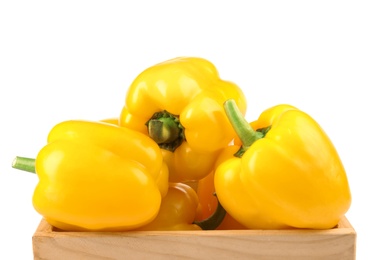 Crate of ripe yellow bell peppers isolated on white, closeup