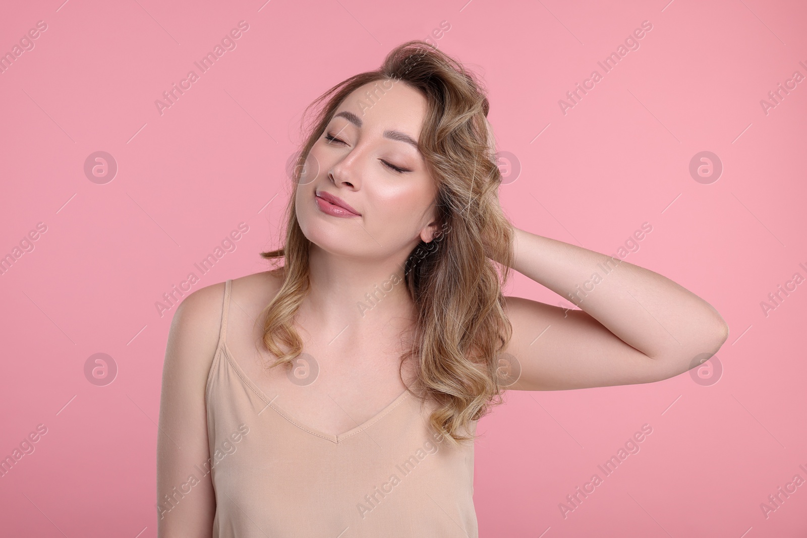 Photo of Portrait of beautiful woman on pink background