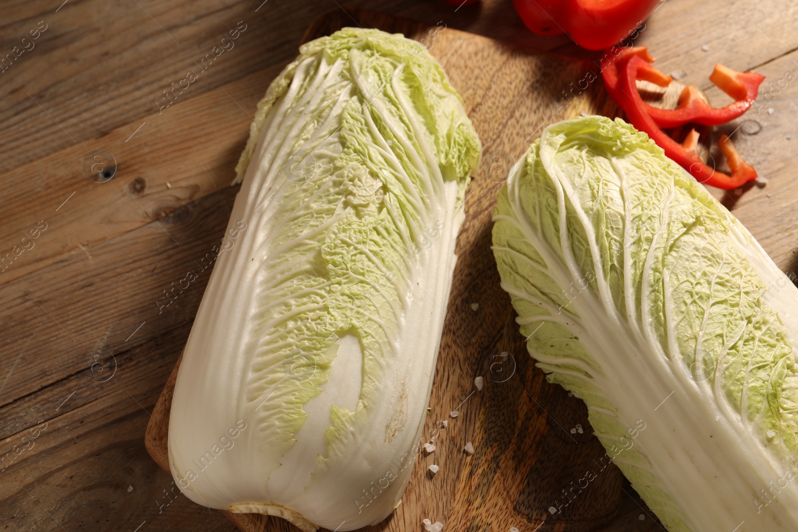 Photo of Fresh Chinese cabbages and bell peppers on wooden table, top view