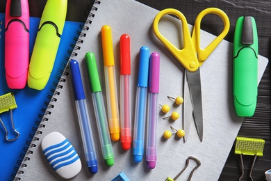 Different school stationery on wooden background, flat lay