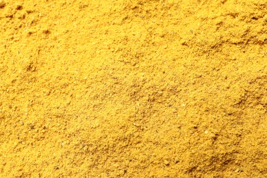 Dry curry powder as background, above view