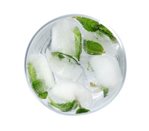 Glass of drink with mint and ice cubes on white background, top view