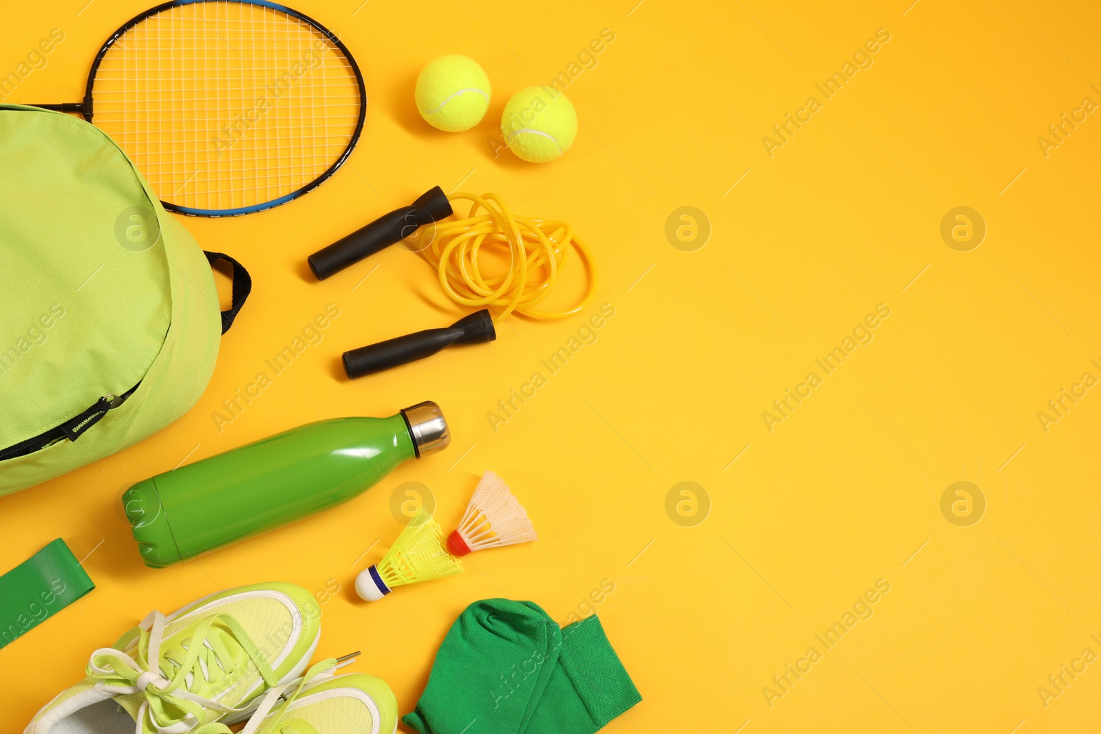 Photo of Different sports equipment on yellow background, flat lay. Space for text