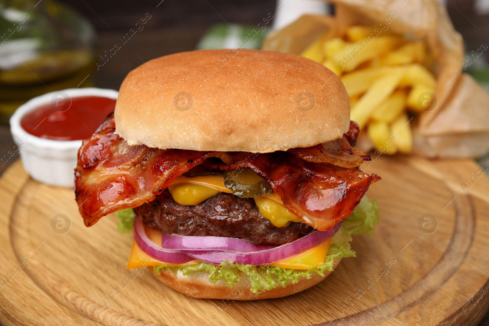 Photo of Tasty burger with bacon, vegetables and patty served with french fries and ketchup on wooden board, closeup