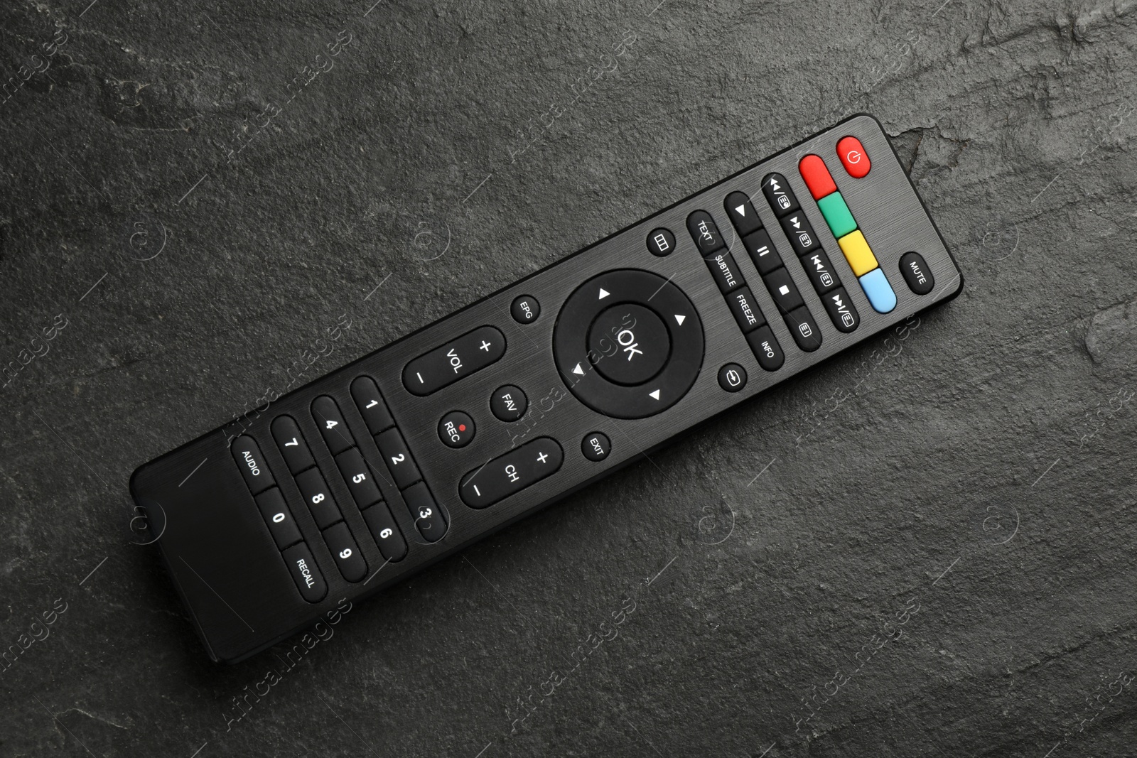 Photo of Modern tv remote control on black table, top view