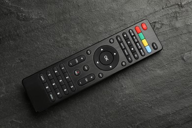 Photo of Modern tv remote control on black table, top view