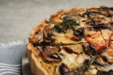 Photo of Delicious quiche with mushrooms on table, closeup