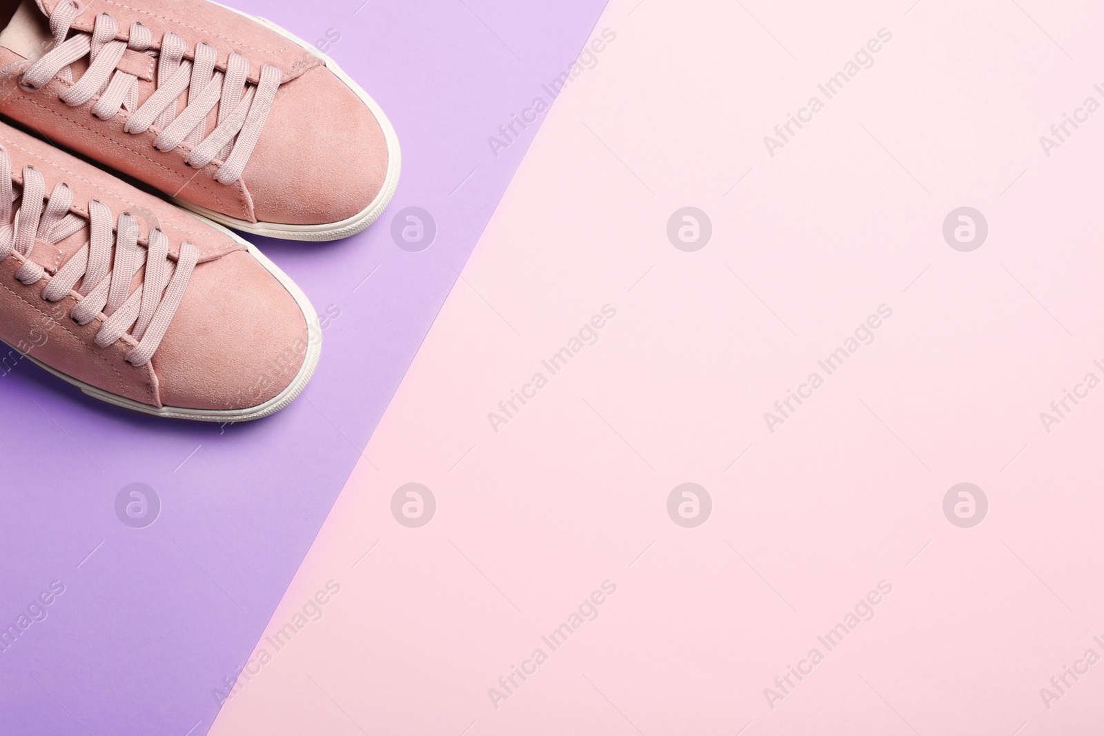 Photo of Bright stylish shoes on color background, top view. Space for text