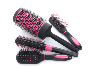 Set of modern hair brushes on white background, above view