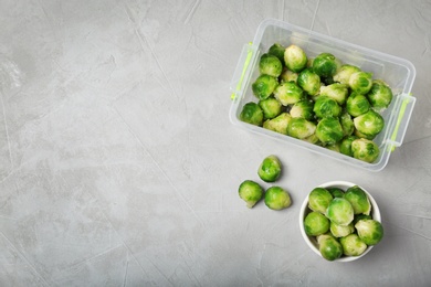 Photo of Flat lay composition with frozen brussel sprouts on light background. Vegetable preservation