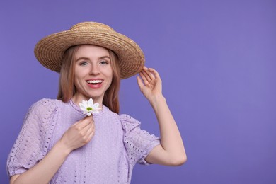 Beautiful woman with spring flower in hand on purple background, space for text