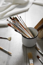 Photo of Different brushes on floor in artist's studio