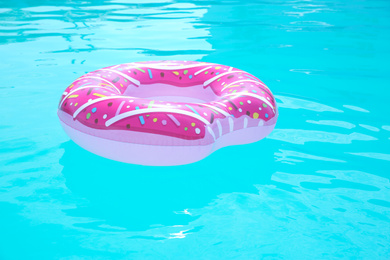 Inflatable ring in swimming pool on sunny day