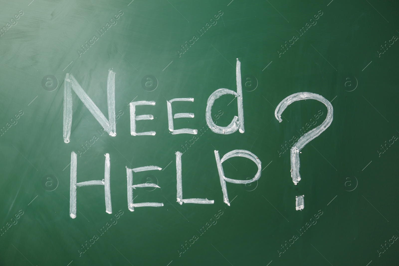 Photo of Phrase "Need help?" written on green chalkboard