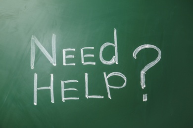 Photo of Phrase "Need help?" written on green chalkboard