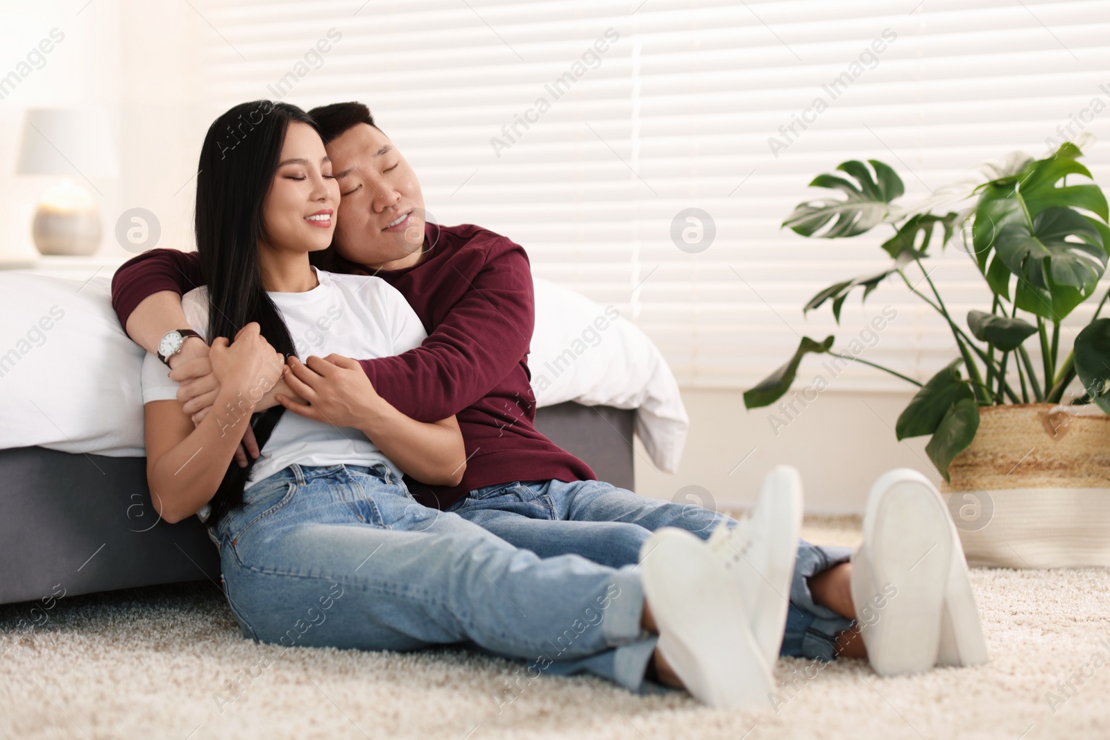 Photo of Lovely young couple on floor at home