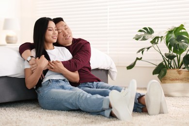 Photo of Lovely young couple on floor at home