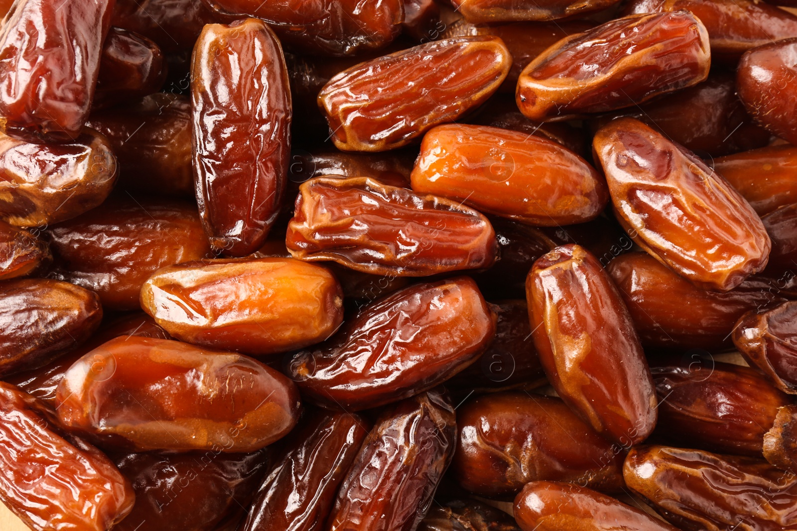 Photo of Tasty sweet dried dates as background, top view