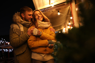 Photo of Happy couple spending time at Christmas fair