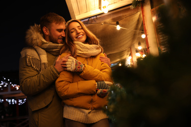 Happy couple spending time at Christmas fair