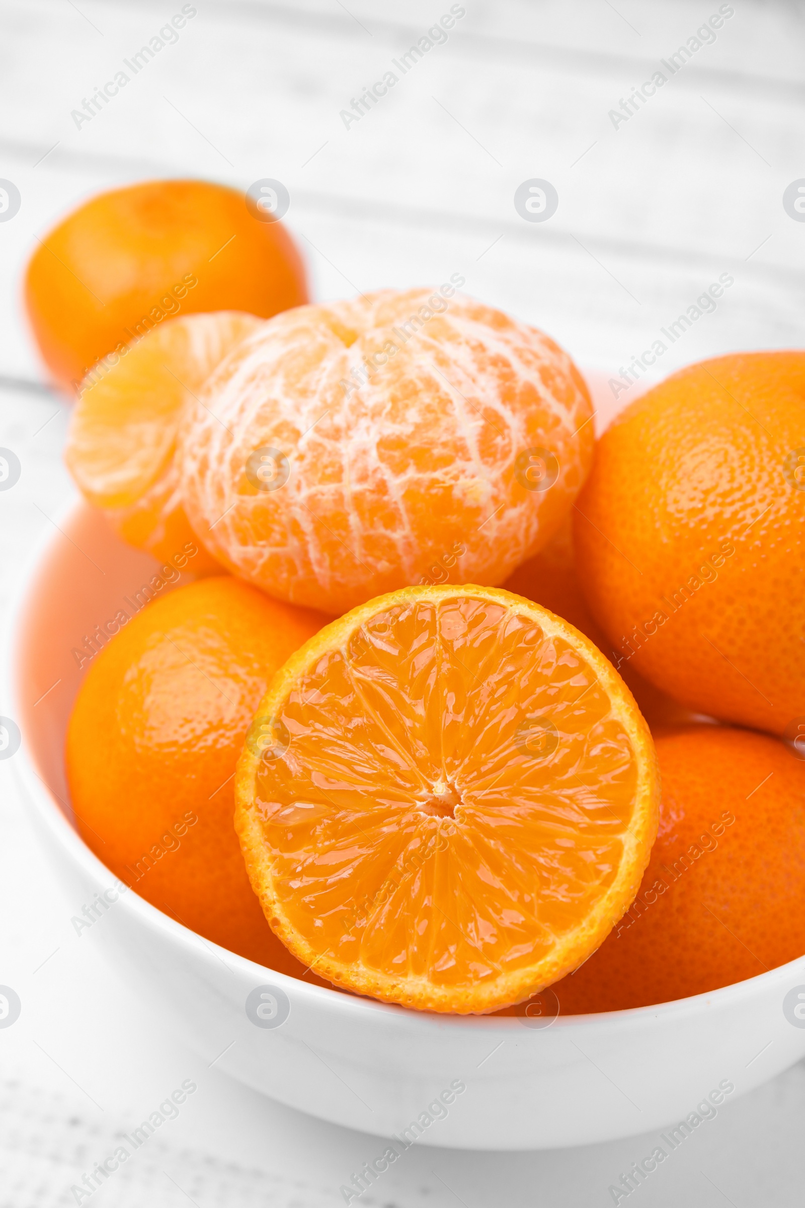 Photo of Fresh juicy tangerines on white wooden table, closeup