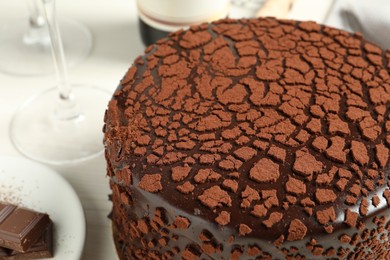 Photo of Delicious chocolate truffle cake on light table, closeup