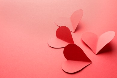 Photo of Paper hearts on red background, closeup. Space for text