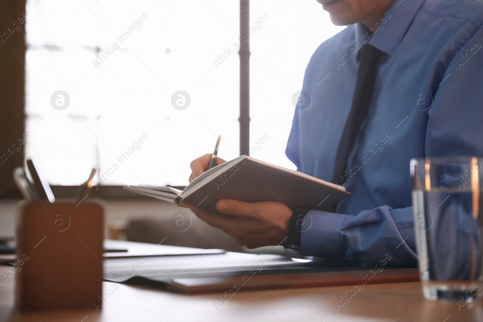 Photo of Male lawyer working at table in office, closeup
