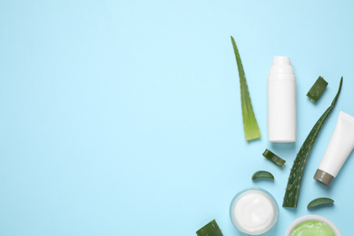 Photo of Flat lay composition with aloe vera and cosmetic products on light blue background. Space for text