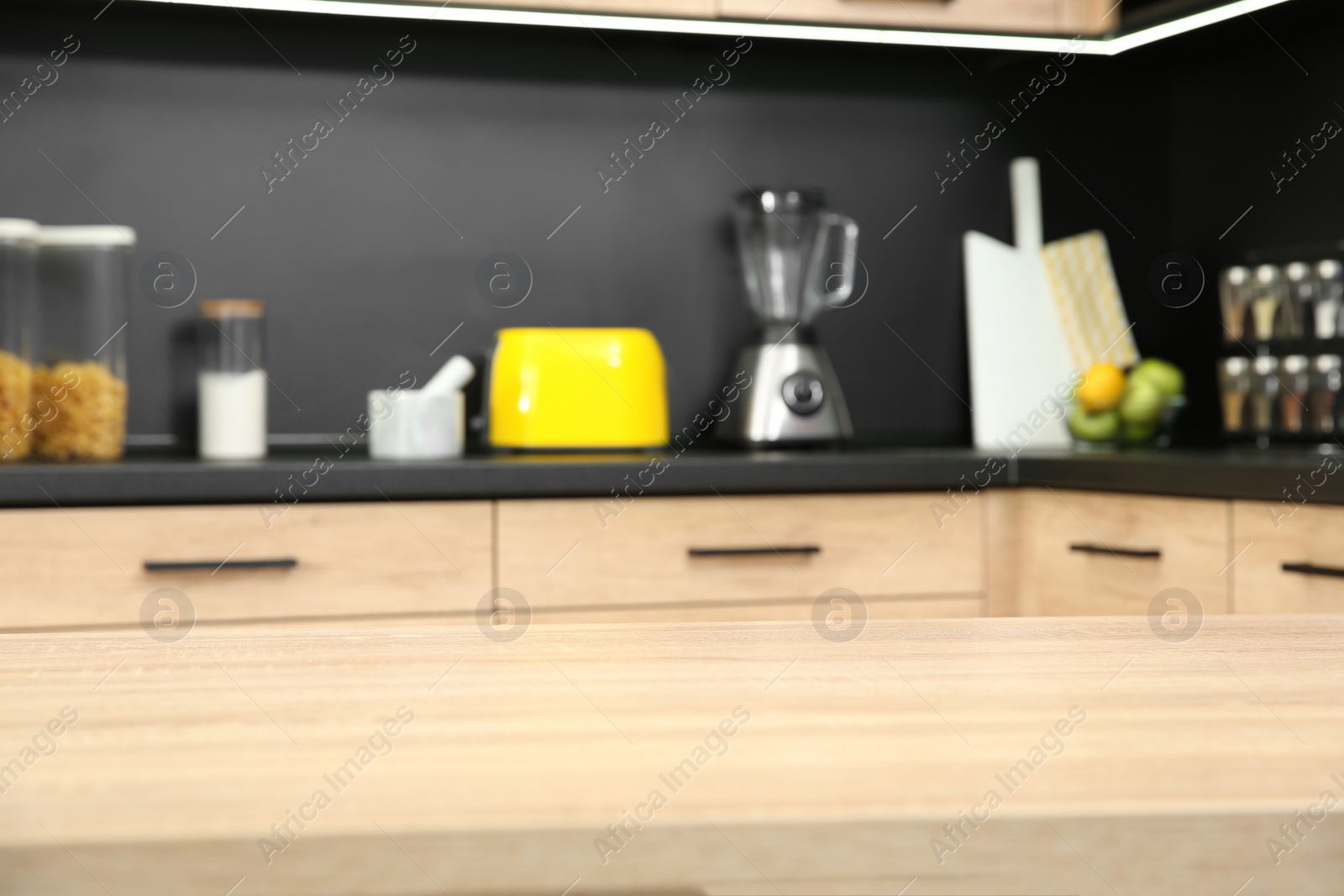 Photo of Countertop and blurred view of kitchen interior on background