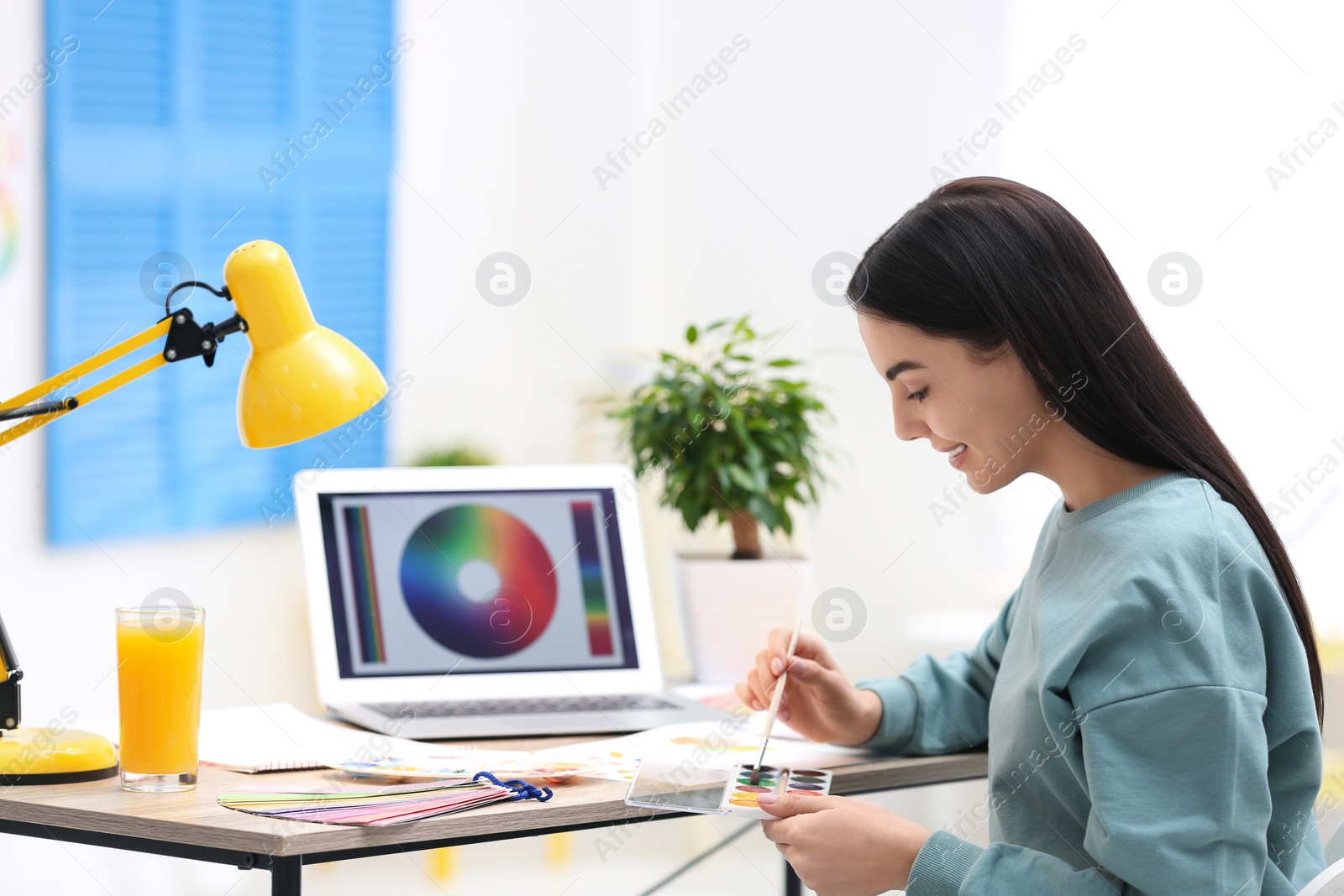 Photo of Female designer working at desk in office