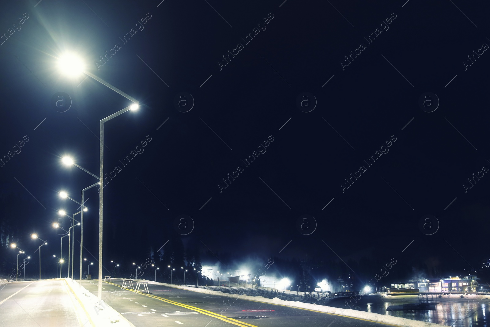 Photo of View of mountain resort near forest at night in winter