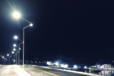 View of mountain resort near forest at night in winter