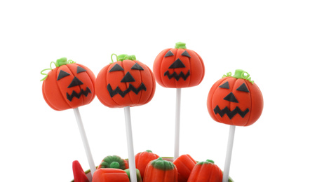 Photo of Delicious jack-o-lantern cake pops on white background. Halloween season