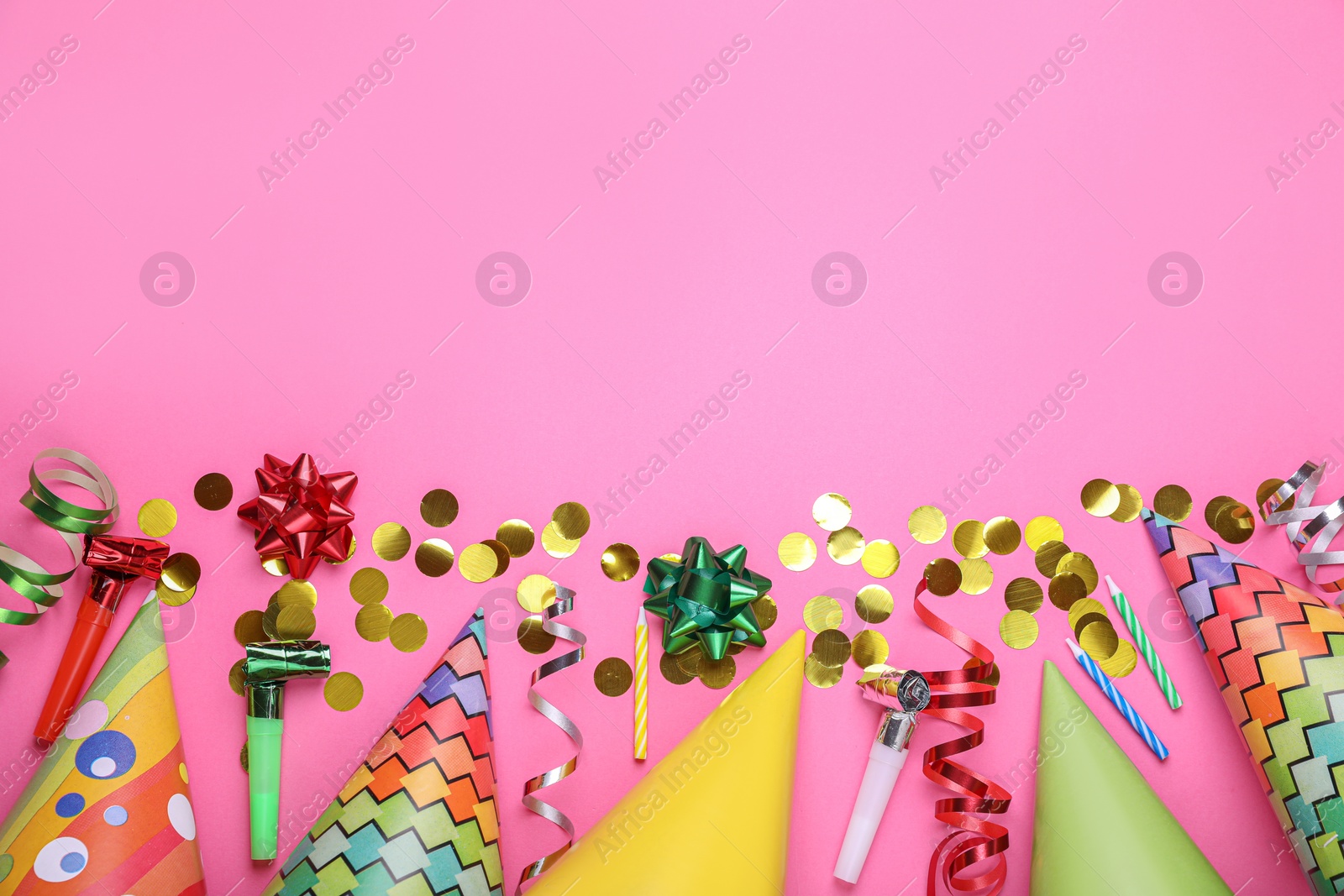 Photo of Flat lay composition with party items on pink background, space for text. Birthday celebration