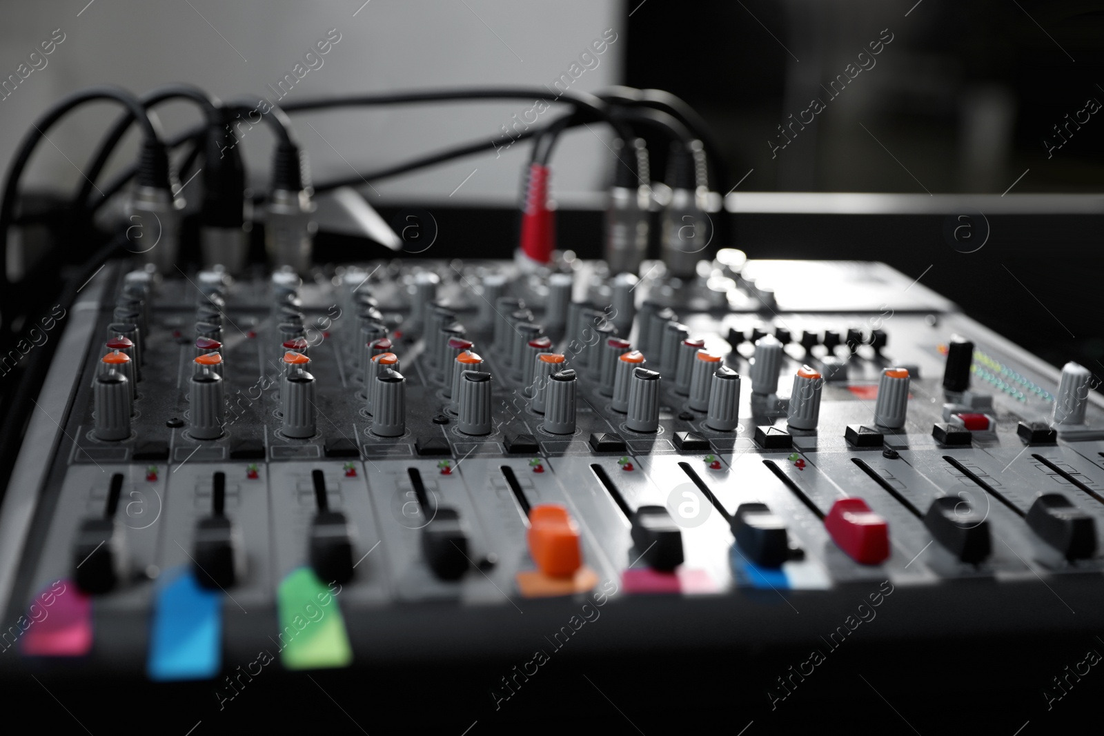 Photo of Modern audio mixing console, closeup. Music equipment