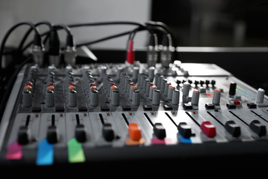 Photo of Modern audio mixing console, closeup. Music equipment