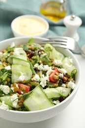 Photo of Delicious salad with lentils, vegetables and feta cheese served on white table, closeup