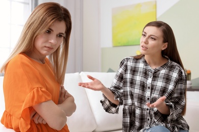 Photo of Women arguing on sofa at home