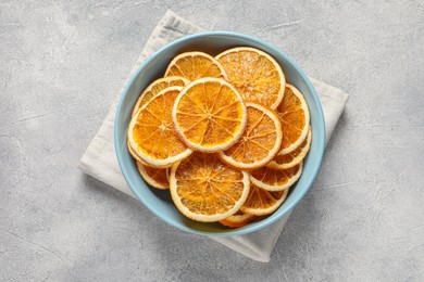 Photo of Many dry orange slices on grey textured table, top view