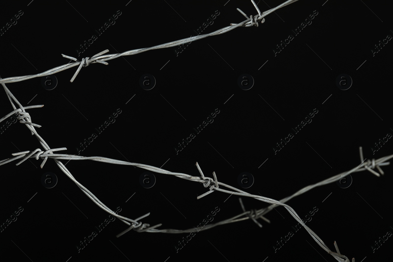 Photo of Shiny metal barbed wire on black background