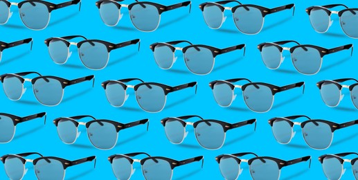 Image of Many stylish sunglasses on turquoise background. Seamless pattern design