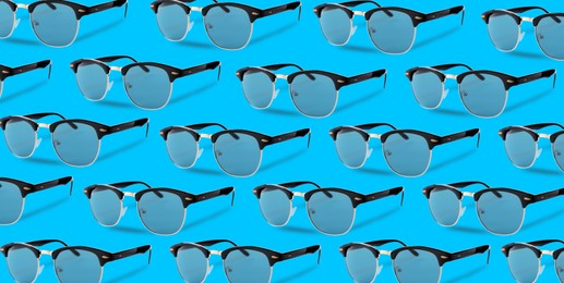 Many stylish sunglasses on turquoise background. Seamless pattern design