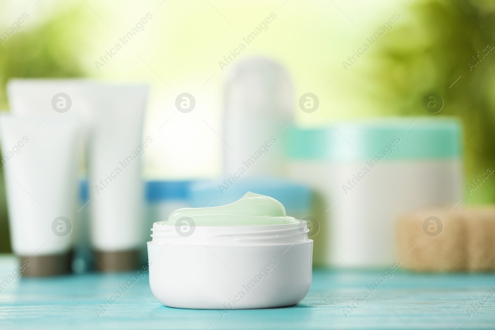 Photo of Jar of body care product on table against blurred background. Space for text