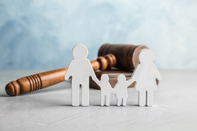 Family figure and gavel on table. Family law concept