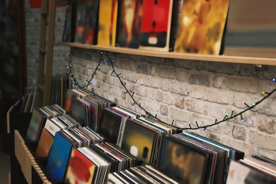 Image of Rack and shelf with different vinyl records in store