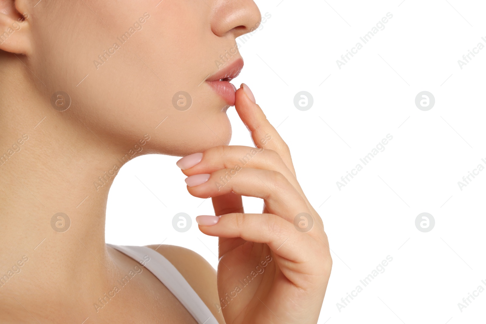 Photo of Young woman with balm on her lips against white background, closeup