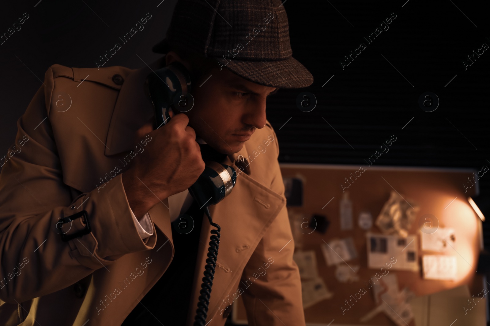 Photo of Old fashioned detective talking on phone in office