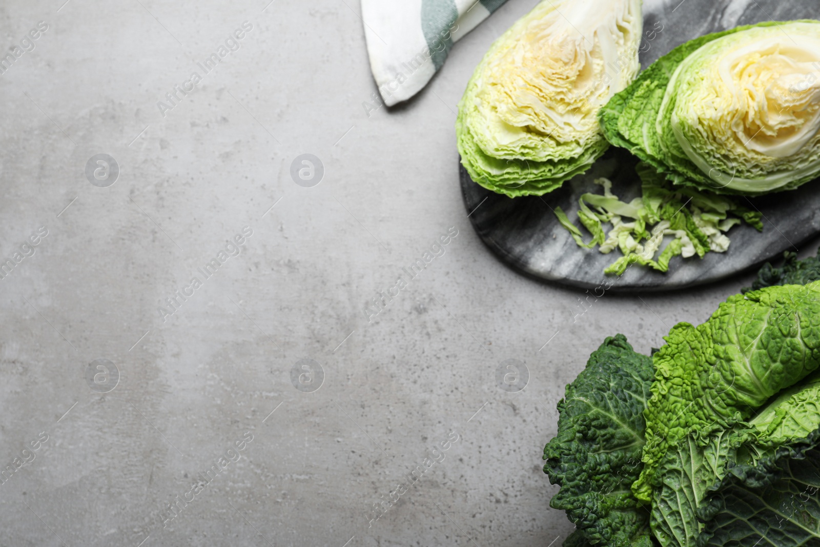 Photo of Fresh savoy cabbages on grey table, flat lay. Space for text