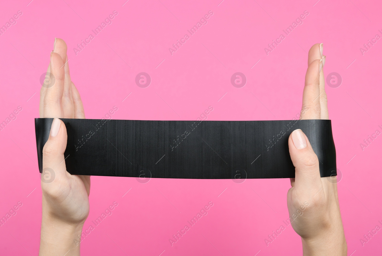 Photo of Woman with fitness elastic band on pink background, closeup